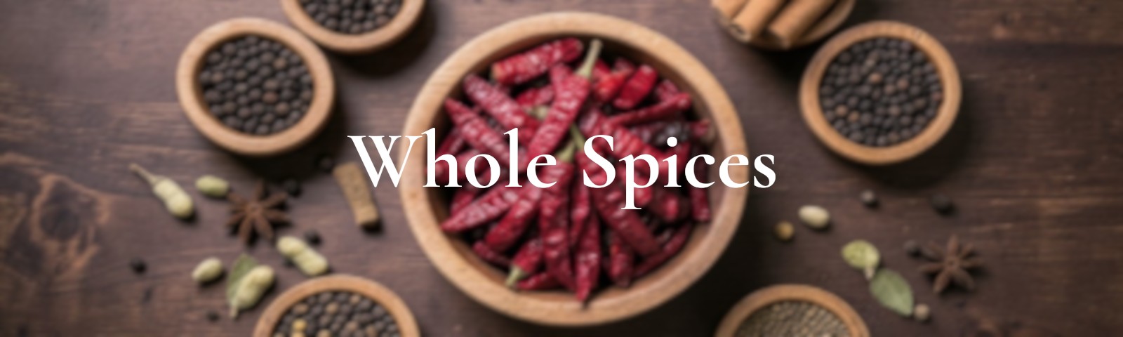 Assorted whole spices like cinnamon, cloves, cardamom and pepper